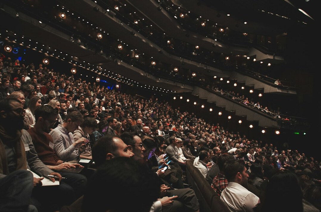 leader on stage with audience