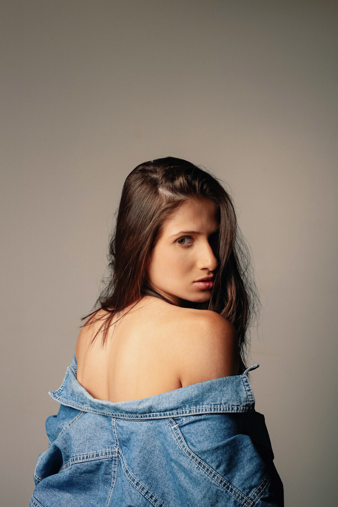 Studio portrait of a confident woman with shoulder-length hair