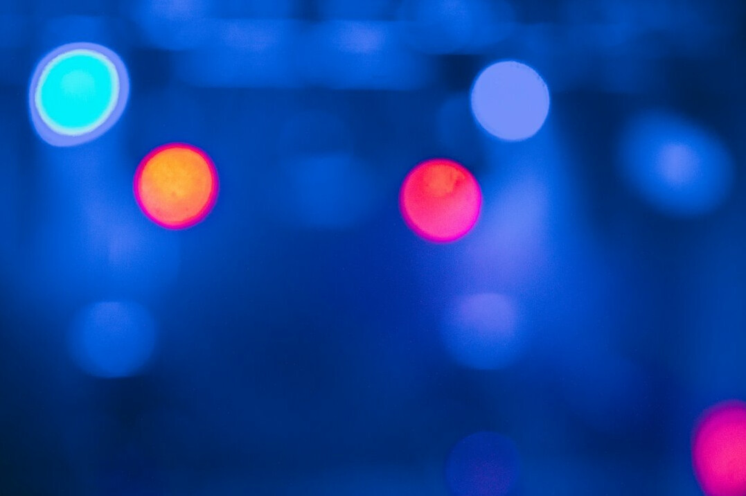 Stage lights glowing in a dark concert hall